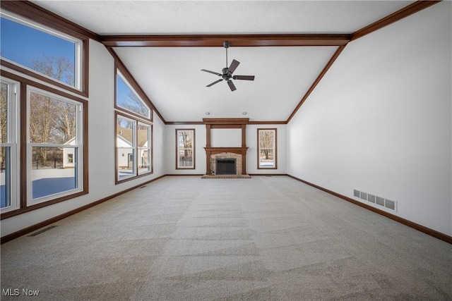 unfurnished living room featuring crown molding, beam ceiling, high vaulted ceiling, carpet flooring, and a fireplace