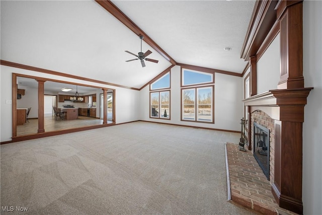 unfurnished living room with ornamental molding, carpet floors, beamed ceiling, ceiling fan, and a fireplace