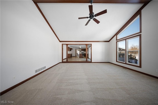 unfurnished living room featuring crown molding, light colored carpet, ceiling fan, and high vaulted ceiling