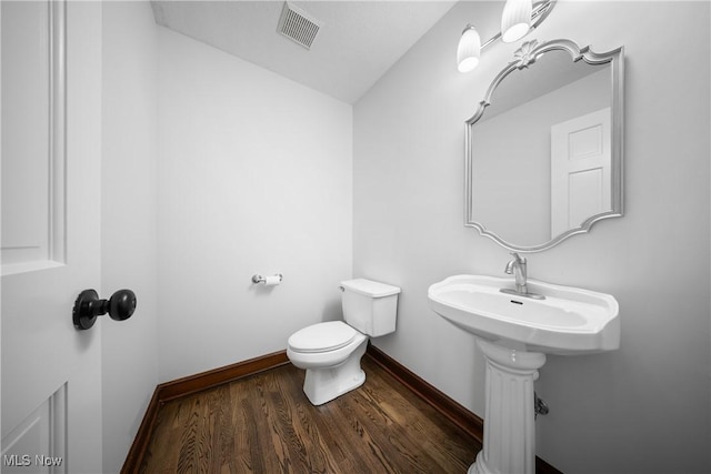 bathroom featuring hardwood / wood-style floors and toilet