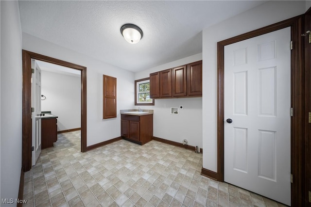 clothes washing area featuring sink, cabinets, washer hookup, a textured ceiling, and hookup for an electric dryer