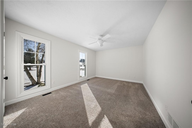 empty room with carpet floors and ceiling fan