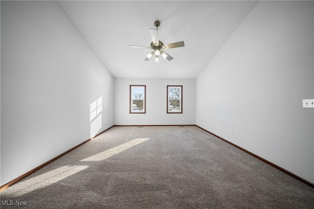 carpeted empty room featuring vaulted ceiling and ceiling fan