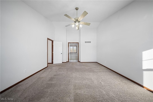 empty room featuring light carpet, high vaulted ceiling, and ceiling fan