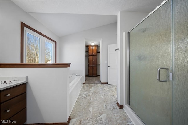 bathroom with lofted ceiling, shower with separate bathtub, and vanity