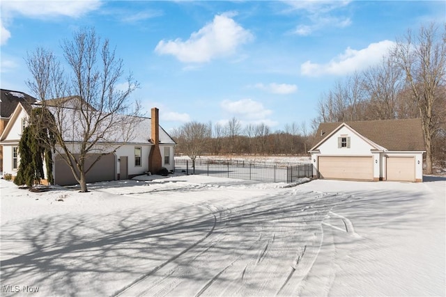 yard covered in snow with a garage