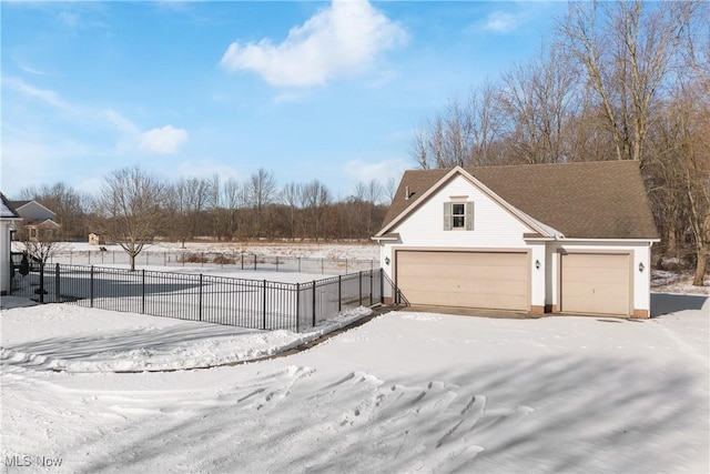 yard covered in snow with a garage