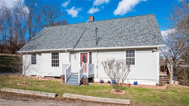 cape cod home with a front yard