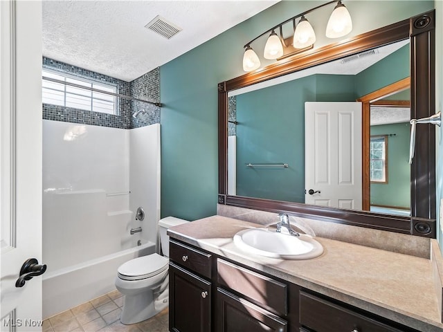 full bathroom with tile patterned floors, toilet, a textured ceiling, shower / tub combination, and vanity