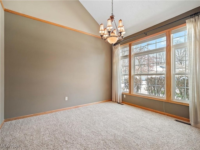 empty room with carpet flooring, vaulted ceiling, and a notable chandelier