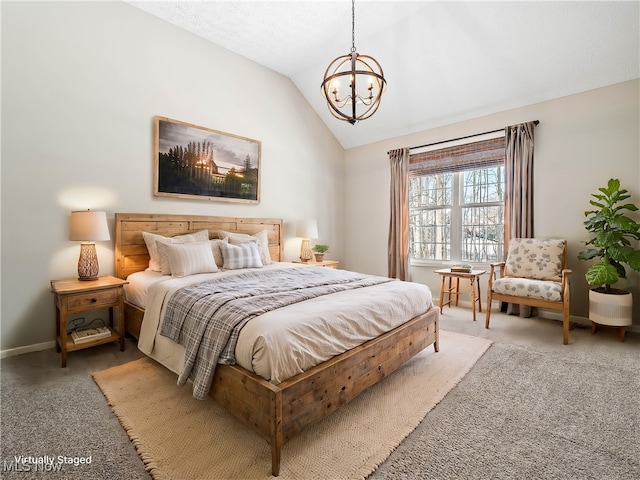 bedroom featuring lofted ceiling, a chandelier, and carpet