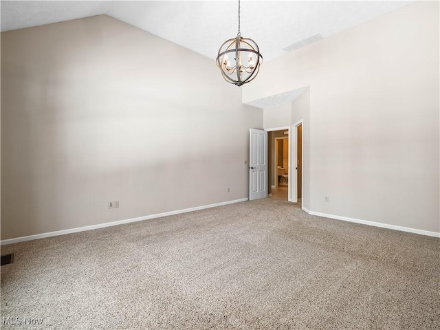 spare room with lofted ceiling, carpet floors, and a notable chandelier