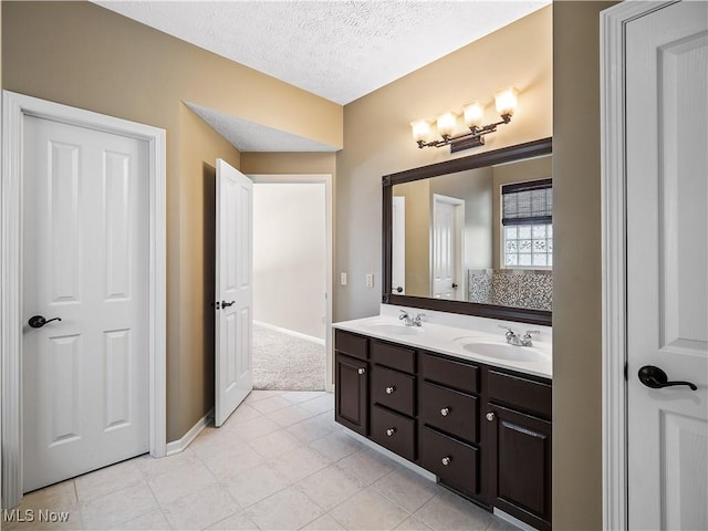 bathroom with vanity and a textured ceiling