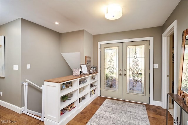 foyer entrance with hardwood / wood-style floors and french doors