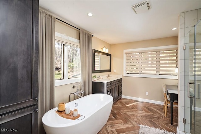 bathroom featuring parquet floors, vanity, and shower with separate bathtub