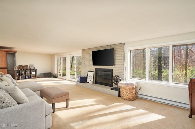 carpeted living room with a fireplace and a baseboard radiator