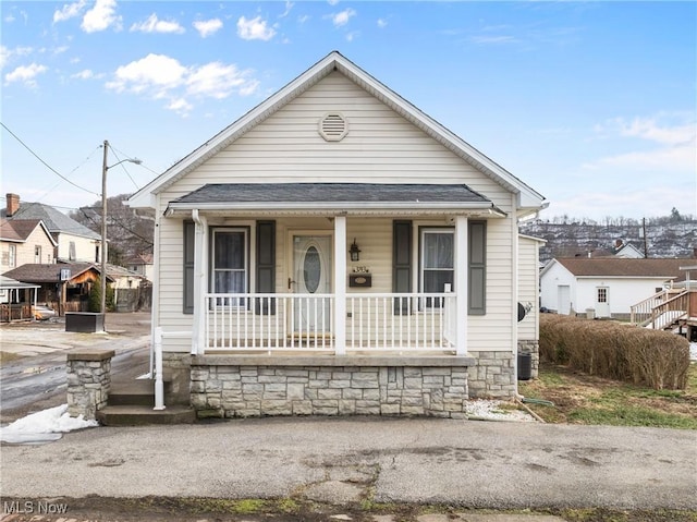 bungalow with central AC unit and covered porch