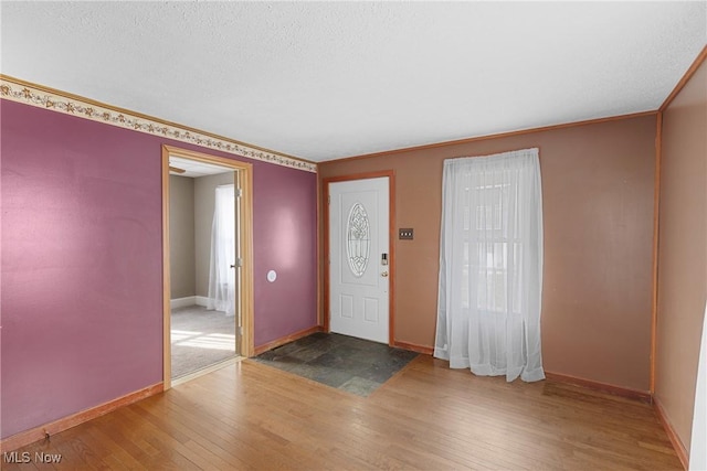 entrance foyer featuring hardwood / wood-style flooring and a textured ceiling