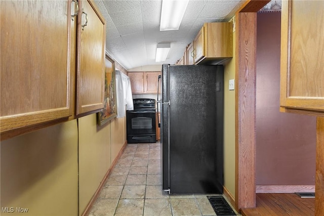 kitchen with lofted ceiling and black appliances