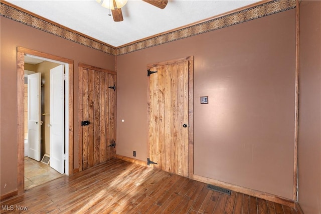 empty room featuring ceiling fan and light wood-type flooring