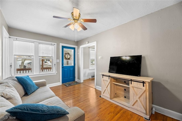 living room with hardwood / wood-style floors and ceiling fan