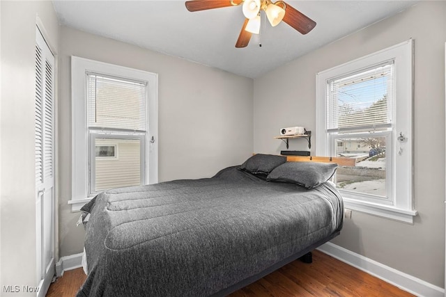 bedroom featuring wood-type flooring, a closet, and ceiling fan