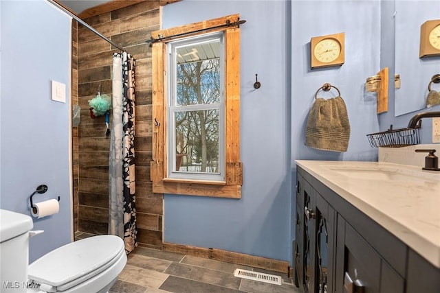 bathroom featuring vanity, toilet, and curtained shower