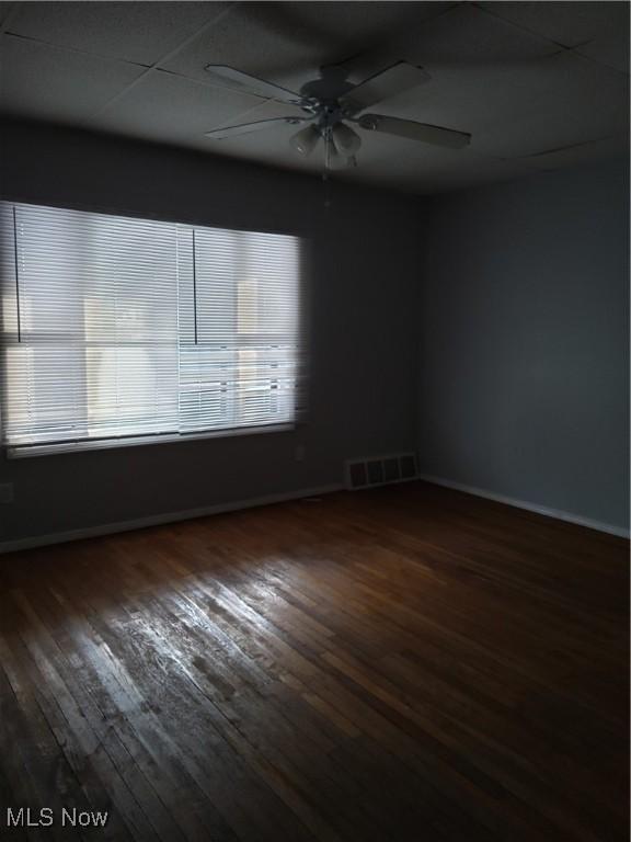 empty room featuring ceiling fan and dark hardwood / wood-style floors