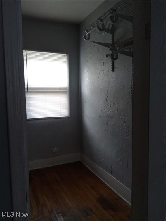 spare room with dark wood-type flooring