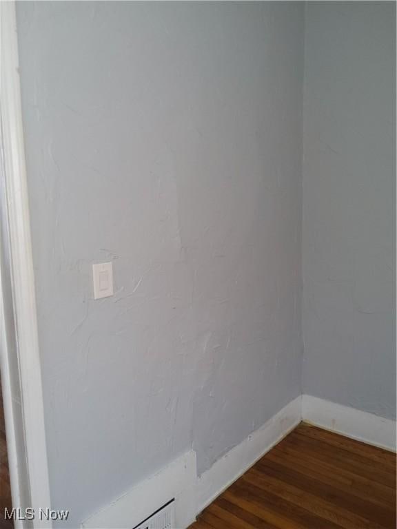 empty room featuring wood-type flooring