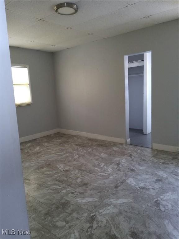 spare room featuring a drop ceiling