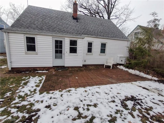 snow covered house with a patio area