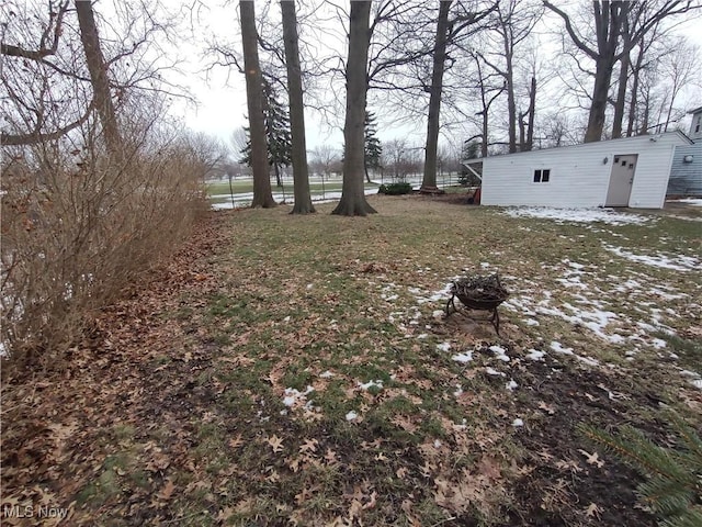 view of yard with a fire pit