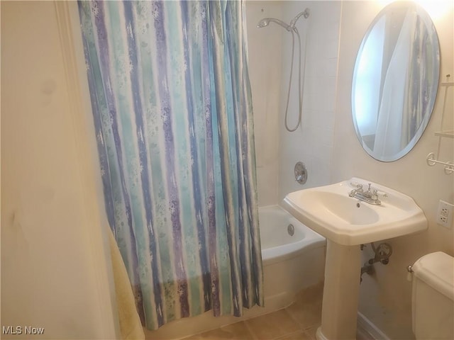 full bathroom featuring sink, shower / bath combination with curtain, tile patterned floors, and toilet