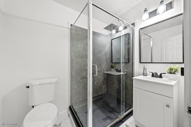 bathroom with a shower with door, vanity, and toilet