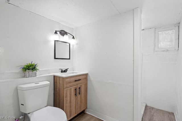 bathroom with vanity, wood-type flooring, and toilet