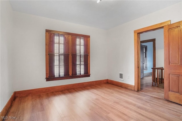 empty room with light hardwood / wood-style floors