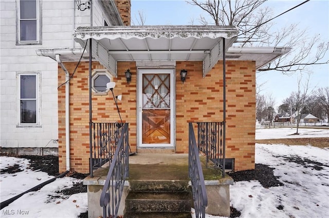 view of snow covered property entrance