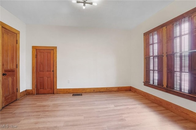 spare room with light wood-type flooring