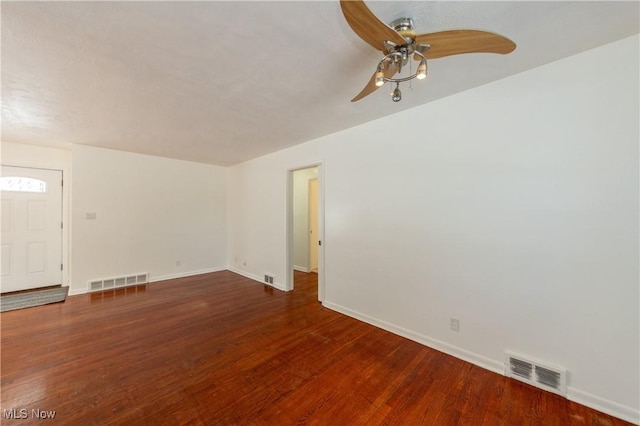 unfurnished living room featuring dark hardwood / wood-style floors and ceiling fan