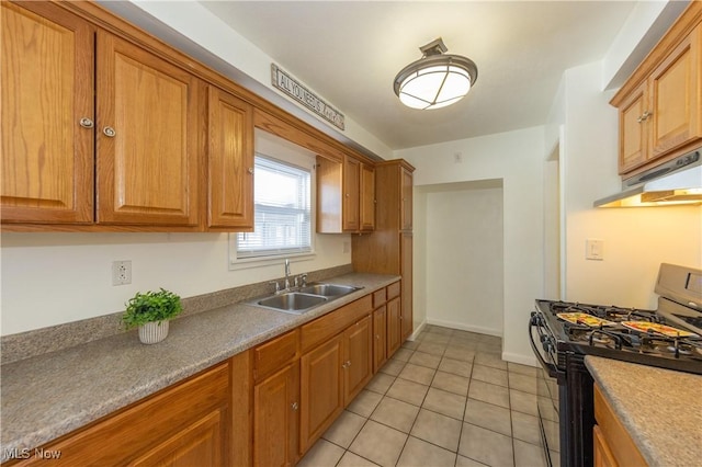 kitchen with light tile patterned floors, sink, and black gas range oven