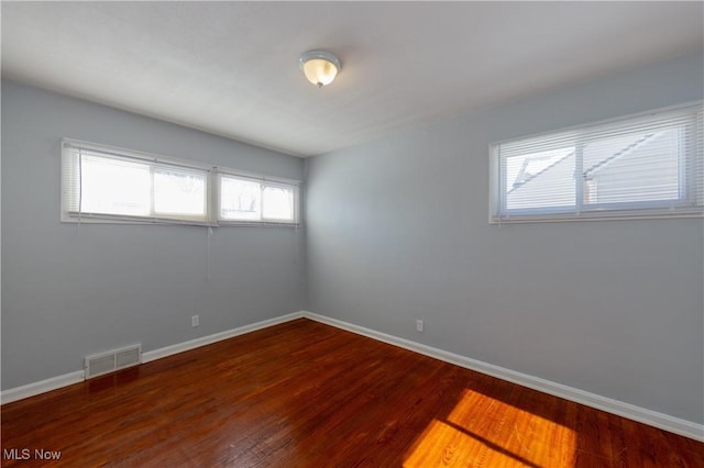 empty room featuring dark wood-type flooring