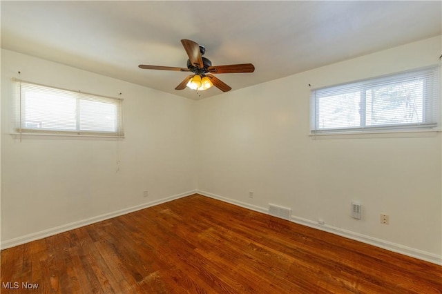 spare room featuring hardwood / wood-style flooring and ceiling fan