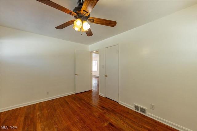 unfurnished room featuring ceiling fan and dark hardwood / wood-style flooring