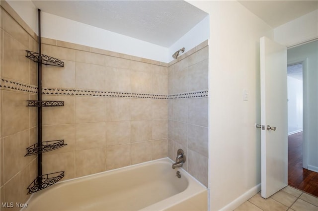 bathroom featuring tiled shower / bath and tile patterned flooring