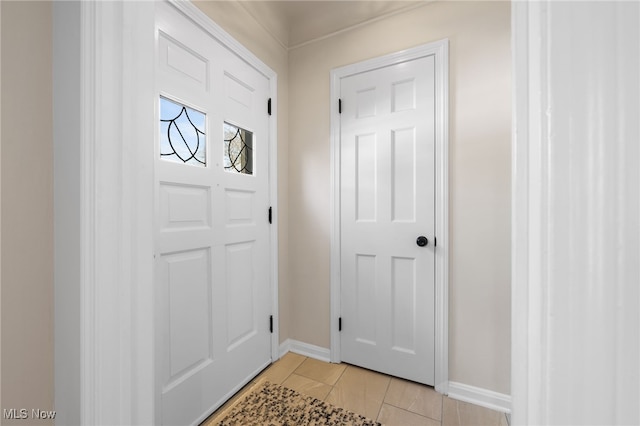 doorway to outside with light tile patterned floors