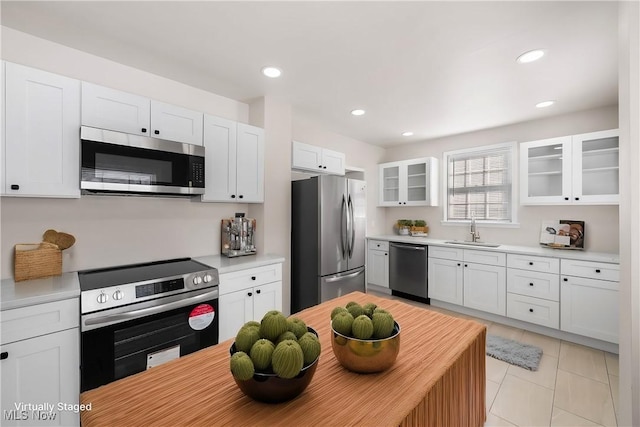 kitchen featuring white cabinetry, sink, and appliances with stainless steel finishes