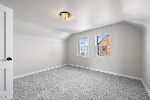 bonus room featuring lofted ceiling and carpet