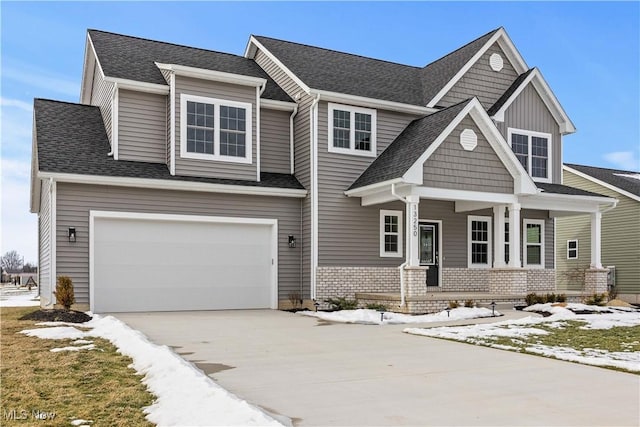 craftsman inspired home with a garage and covered porch