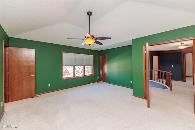 unfurnished bedroom with light carpet, lofted ceiling, and ceiling fan